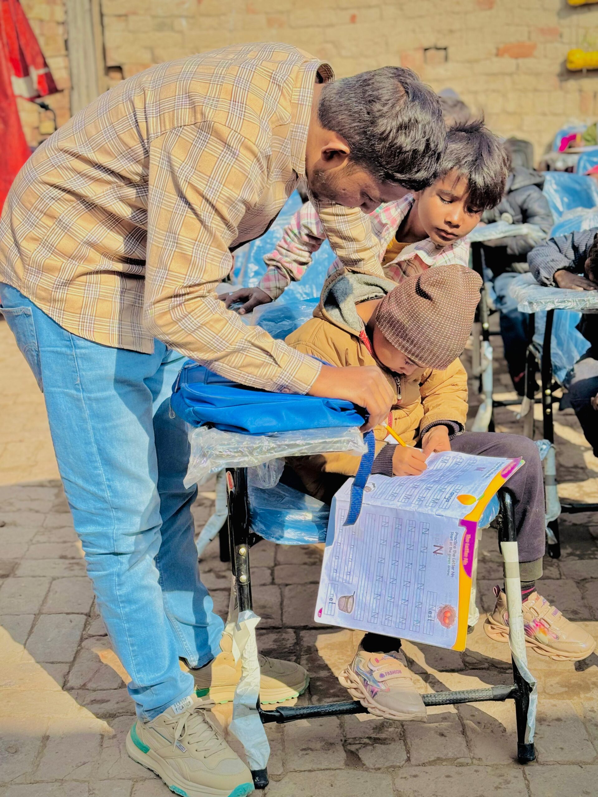 Ministry leader helping a child with education support in Pakistan