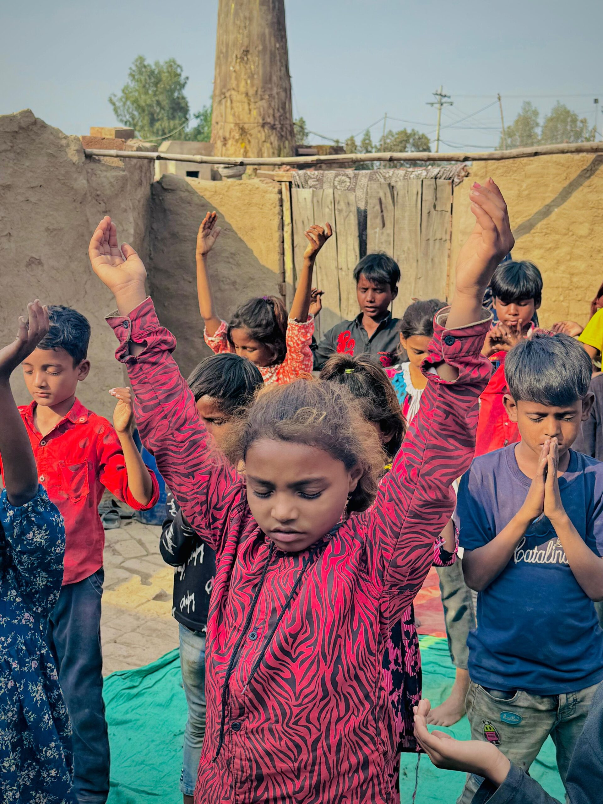 Children praying together during Kingdom First Mission Gospel outreach
