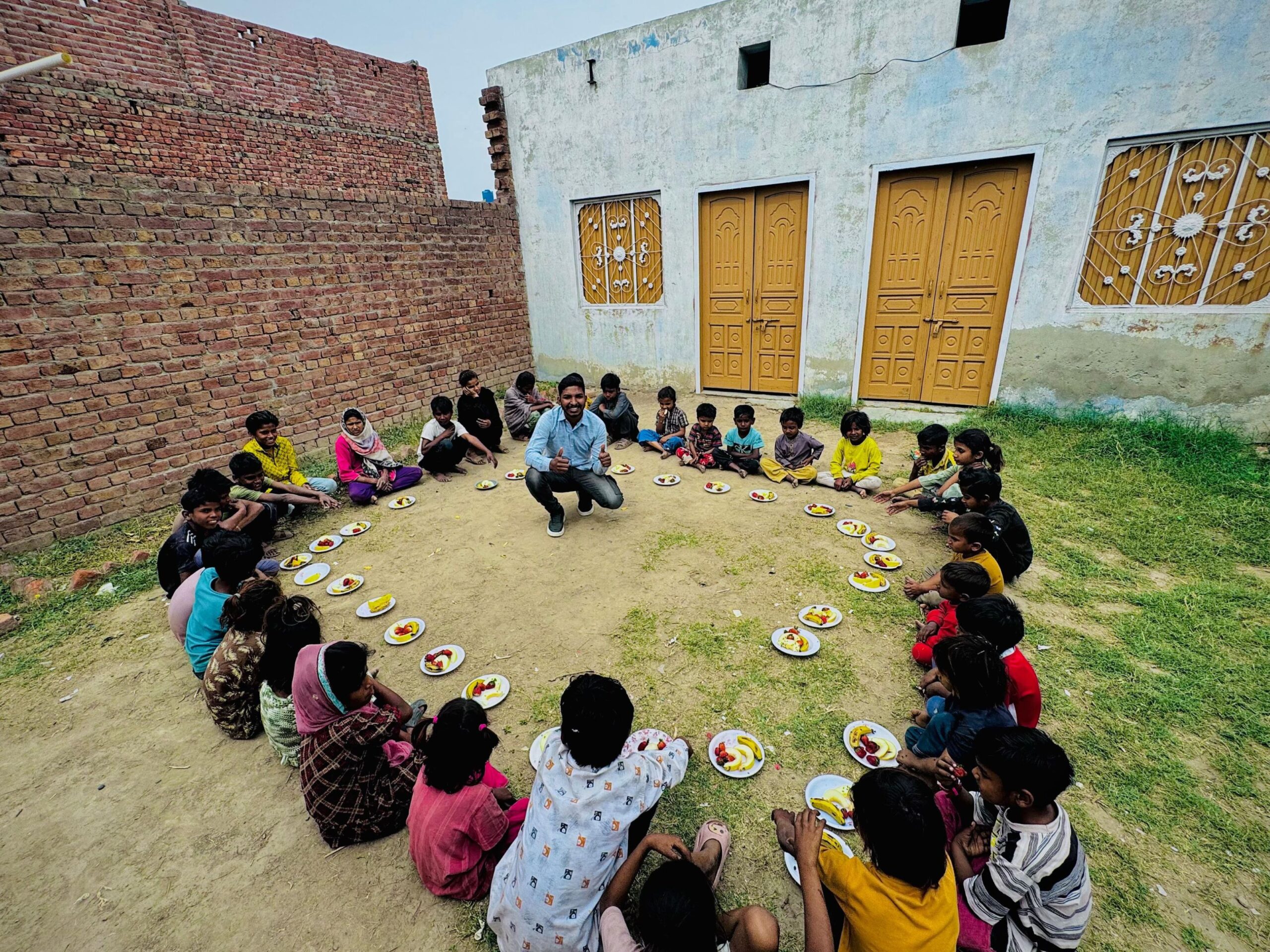 Children seated with food support through Kingdom First Mission in Pakistan