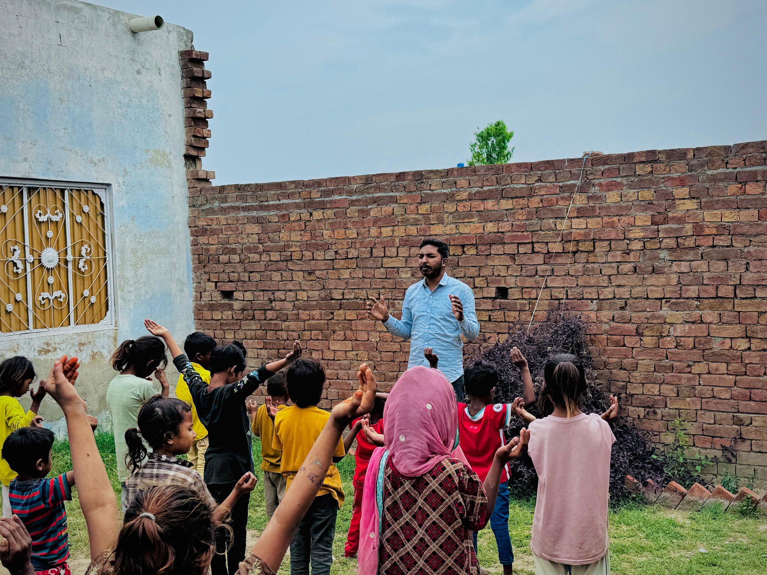 Children gathered with a ministry leader during Kingdom First Mission outreach