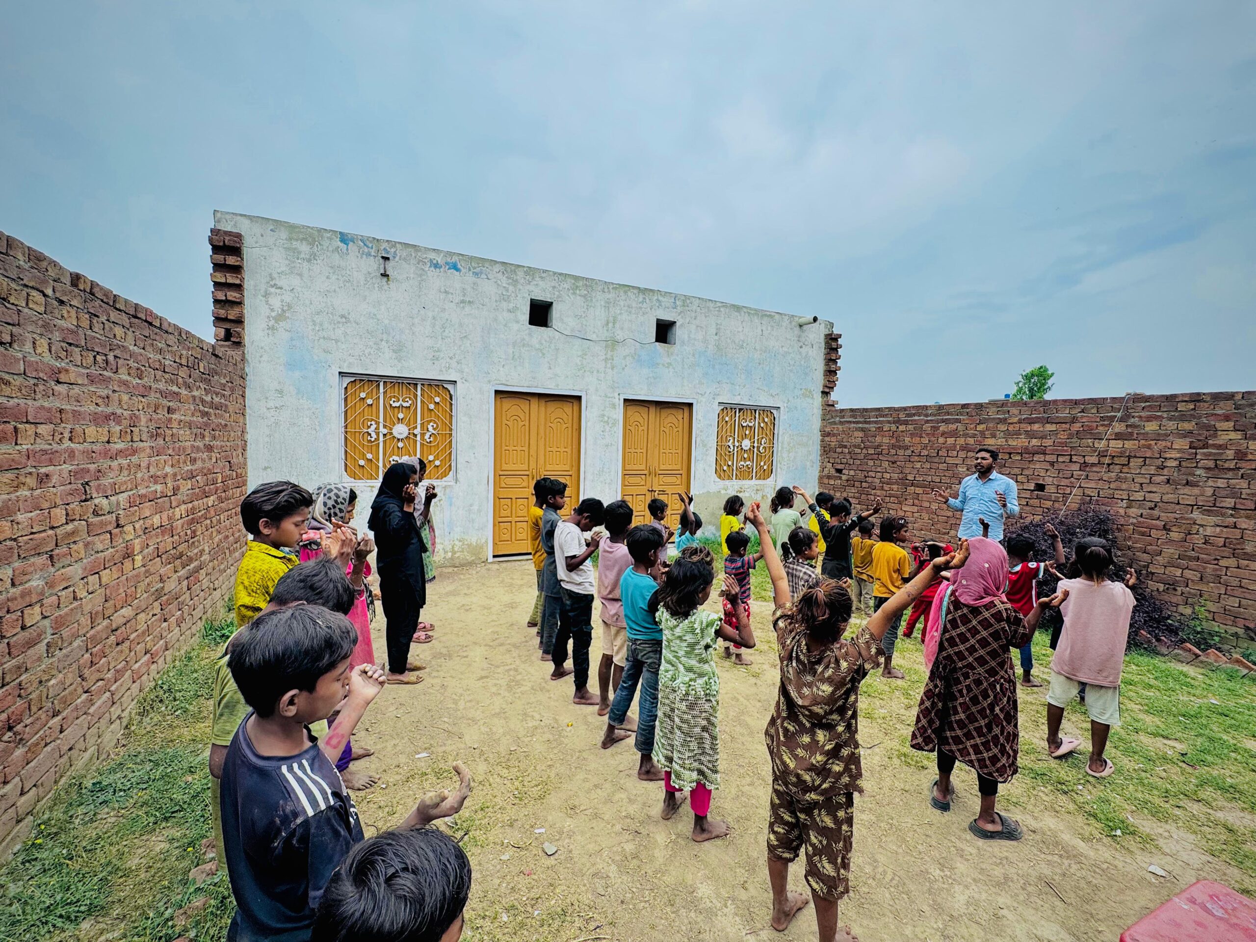 Ministry leader sharing Gospel encouragement with children in Pakistan