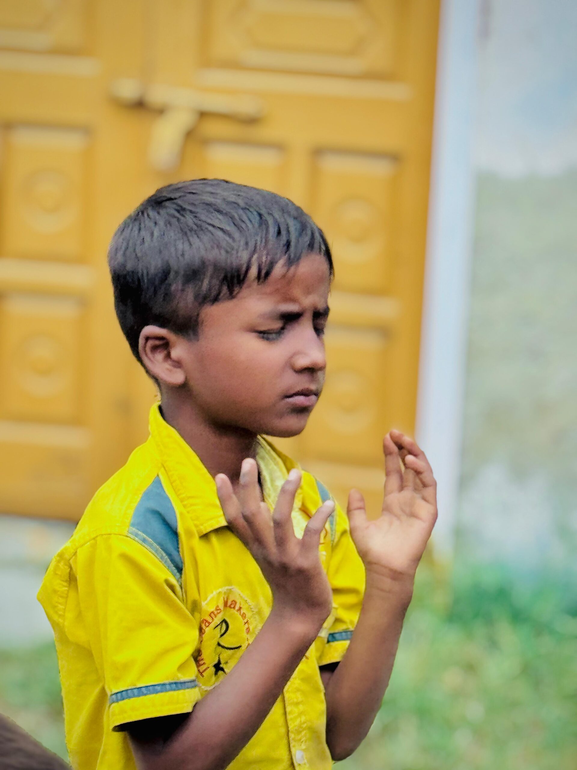 Child praying during Kingdom First Mission children’s ministry in Pakistan