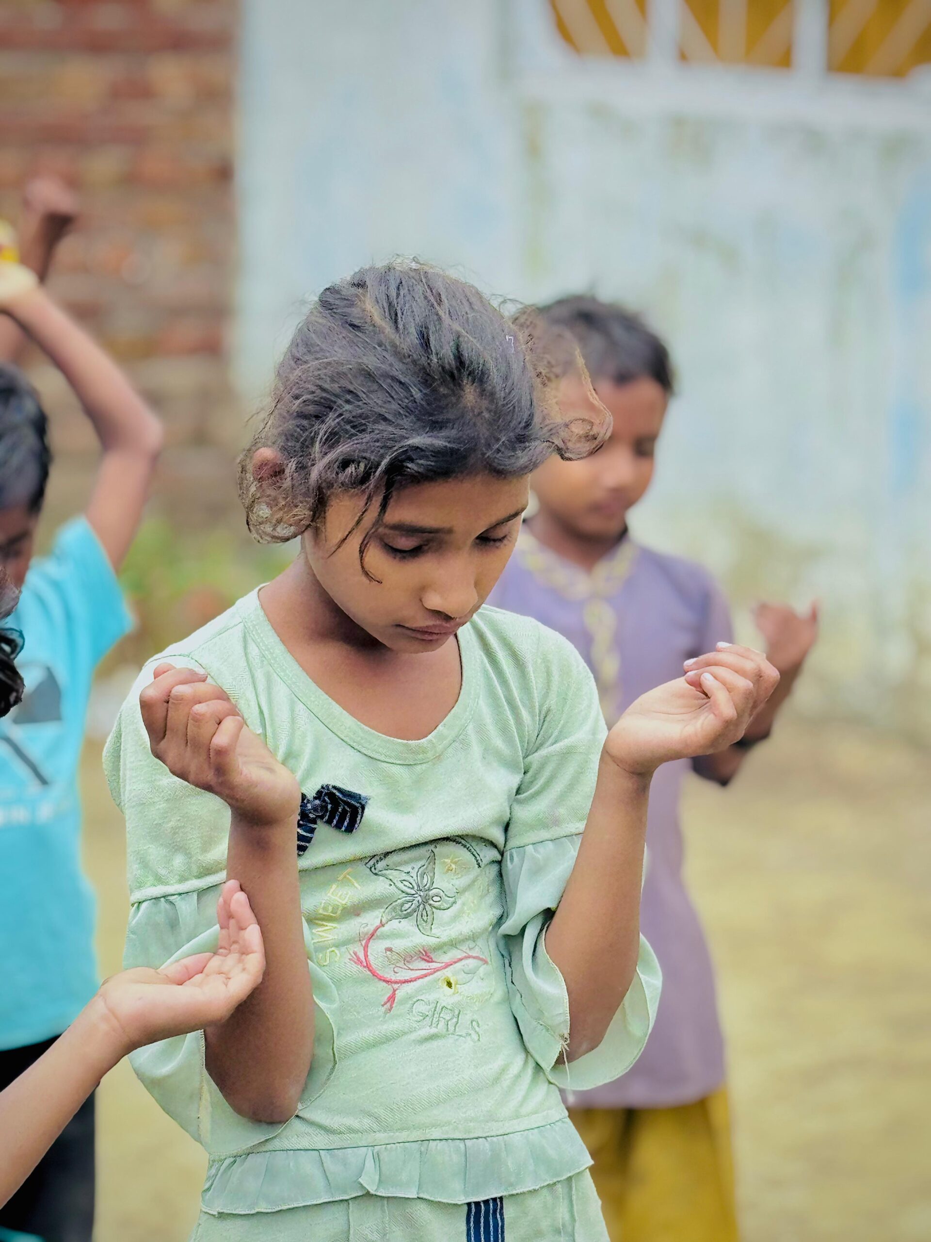 Child praying during Kingdom First Mission outreach in Pakistan