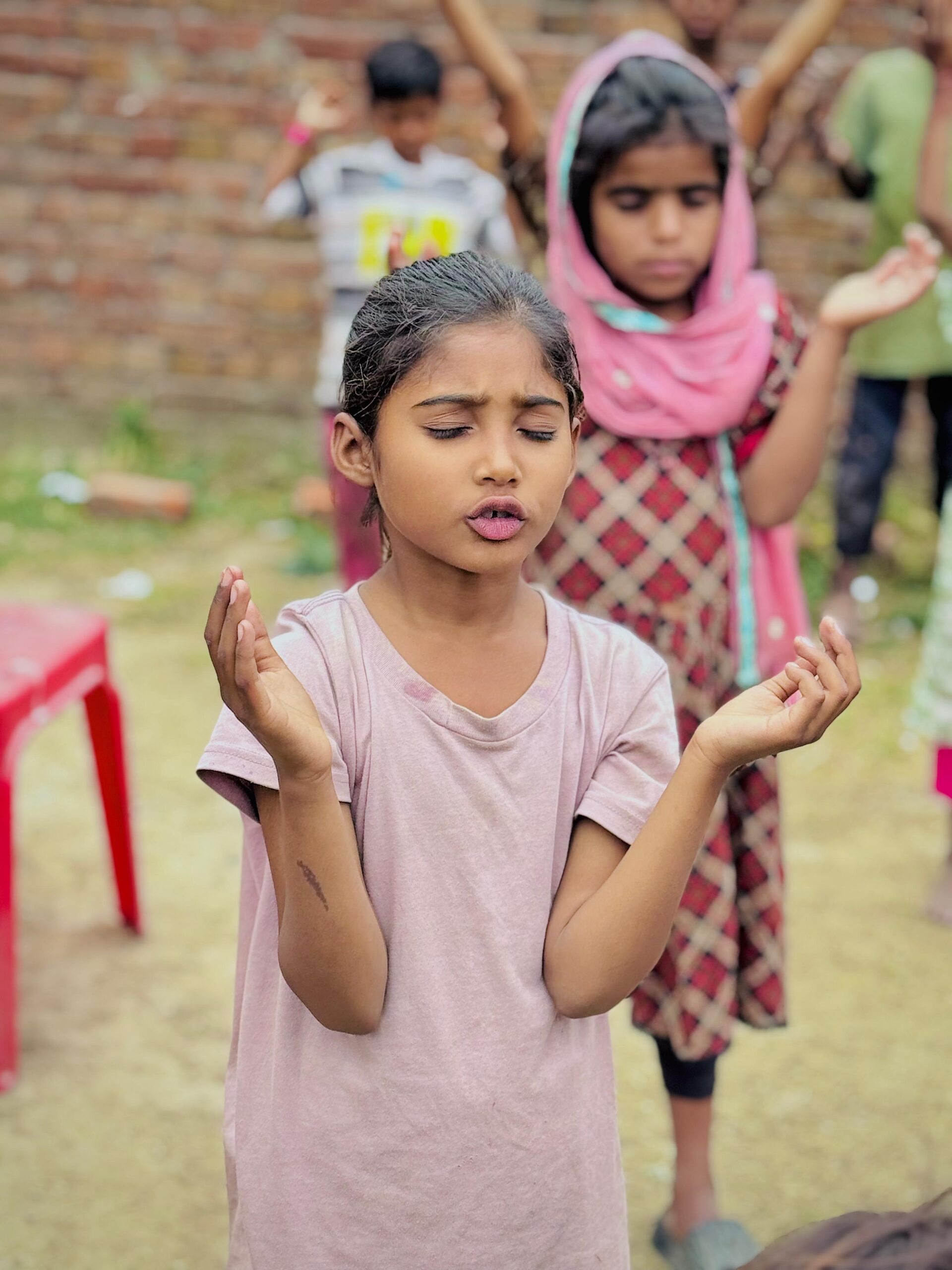 Child praying during Kingdom First Mission children’s ministry
