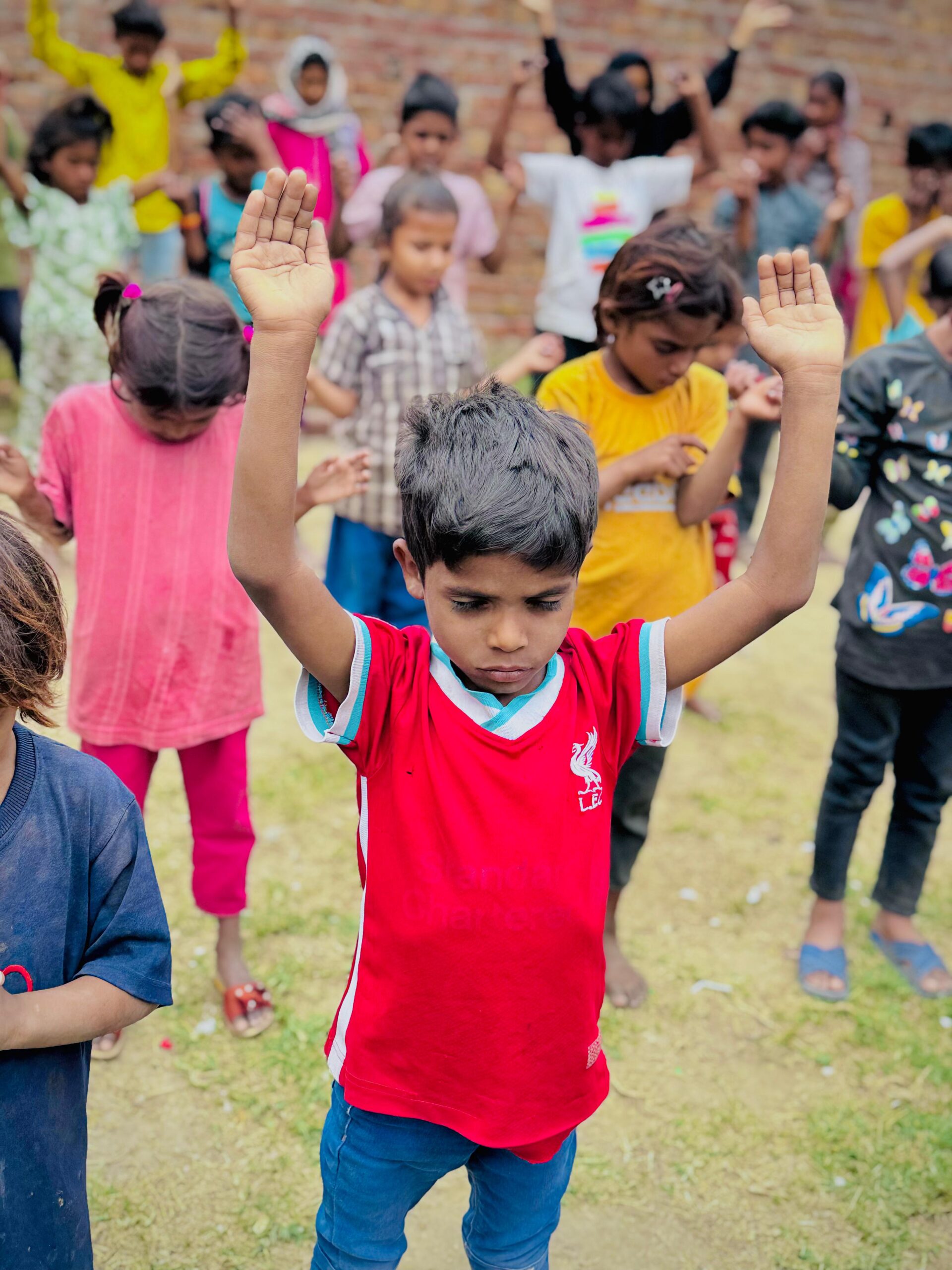 Children praying together during Kingdom First Mission outreach in Pakistan